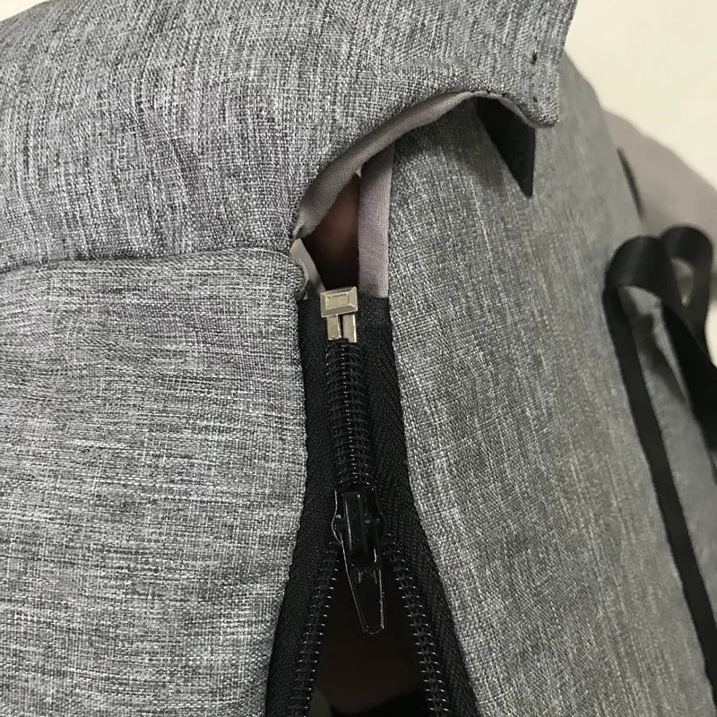 Close-up of grey Carcader backpack zipper with fabric texture detail
