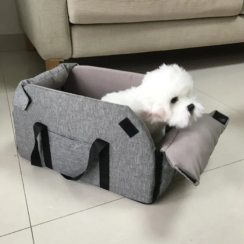 Small white dog in gray portable pet carrier bed on tile floor, Carcader pet accessories