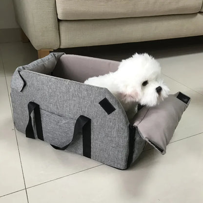 Small white dog in gray portable pet carrier bed on tile floor, Carcader pet accessories