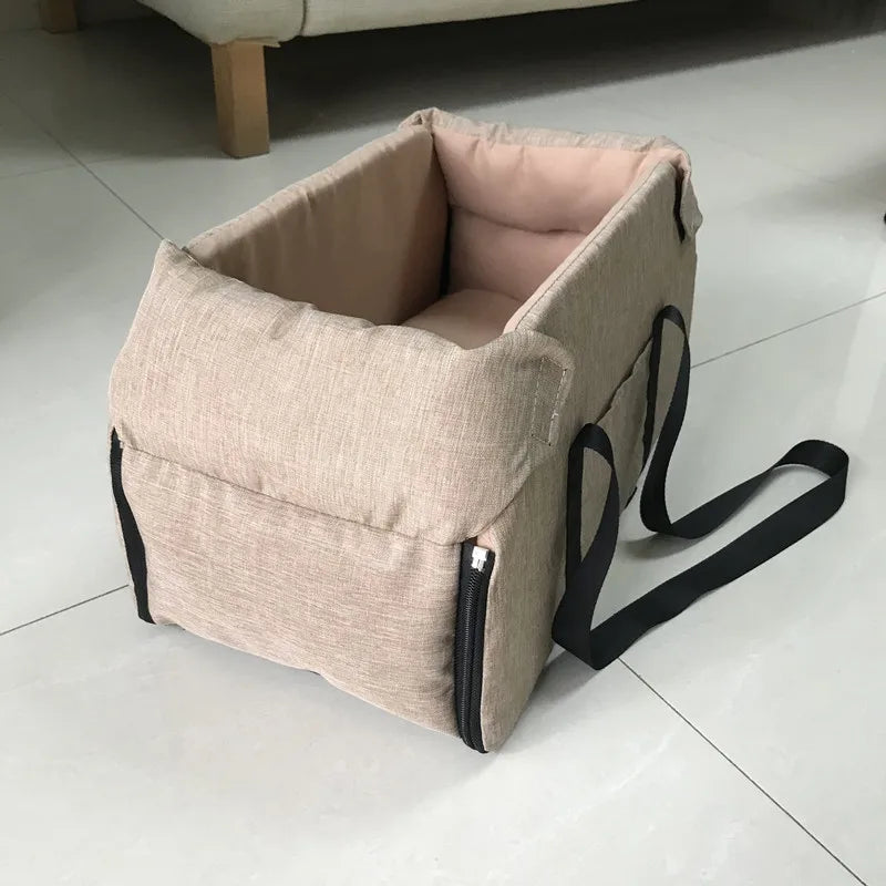 Beige portable pet carrier with black straps on tiled floor, Carcader home accessory