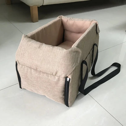Beige portable pet carrier with black straps on tiled floor, Carcader home accessory