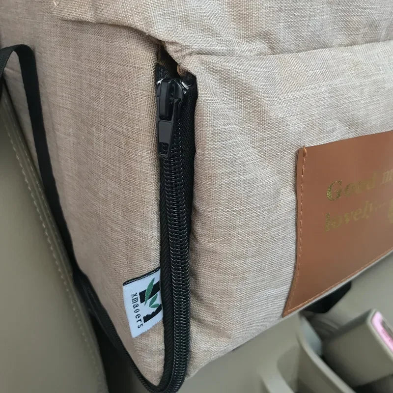 Beige car seat organizer with zipper, Carcader label, attached to car seat